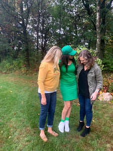 Friends gathered while one woman is wearing a Monochrome green pencil skirt.