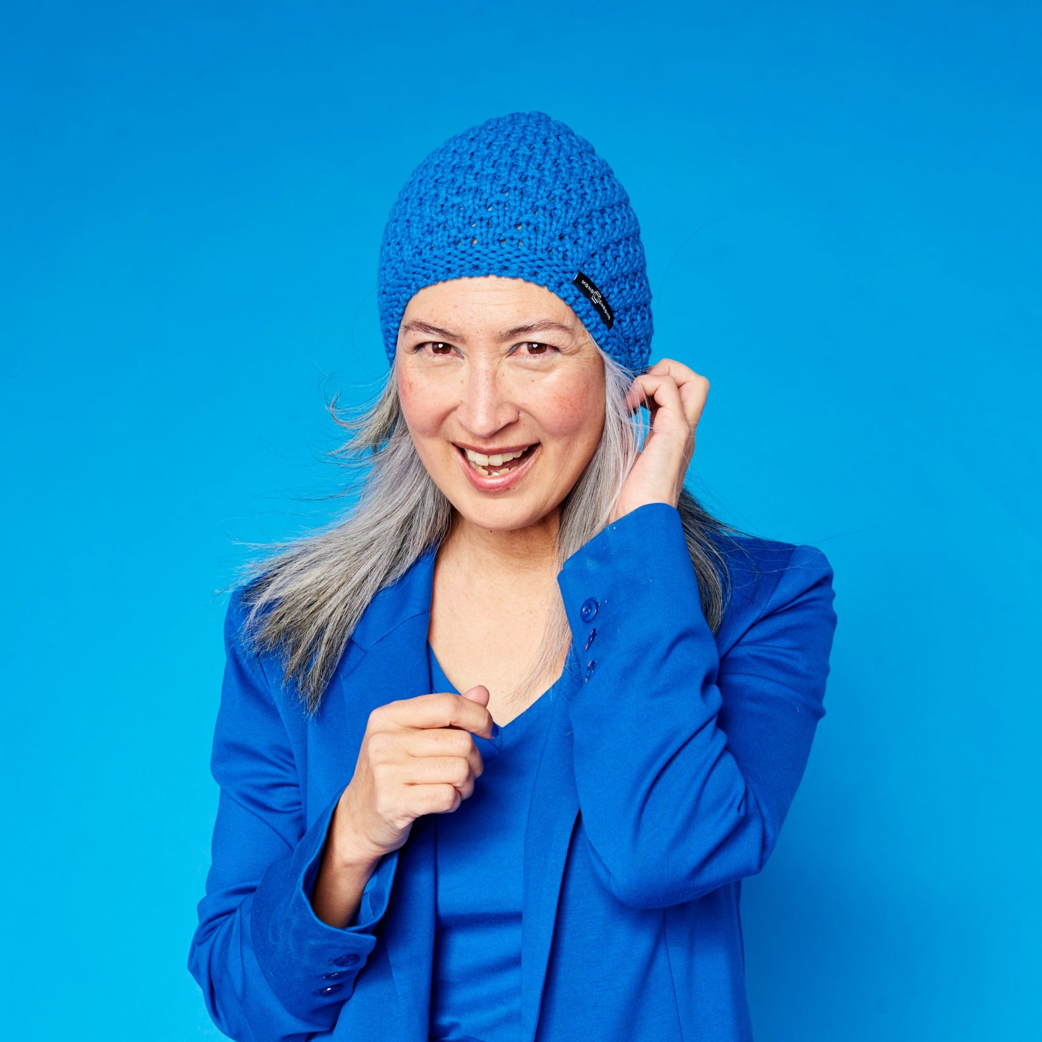 Monochrome blue winter hat, blue warm hat, blue knitted hat with blue jacket, and blue t-shirt.